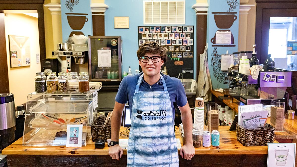 Carson Moore, the CEO of Meantime Coffee Company, in front of the coffee bar.