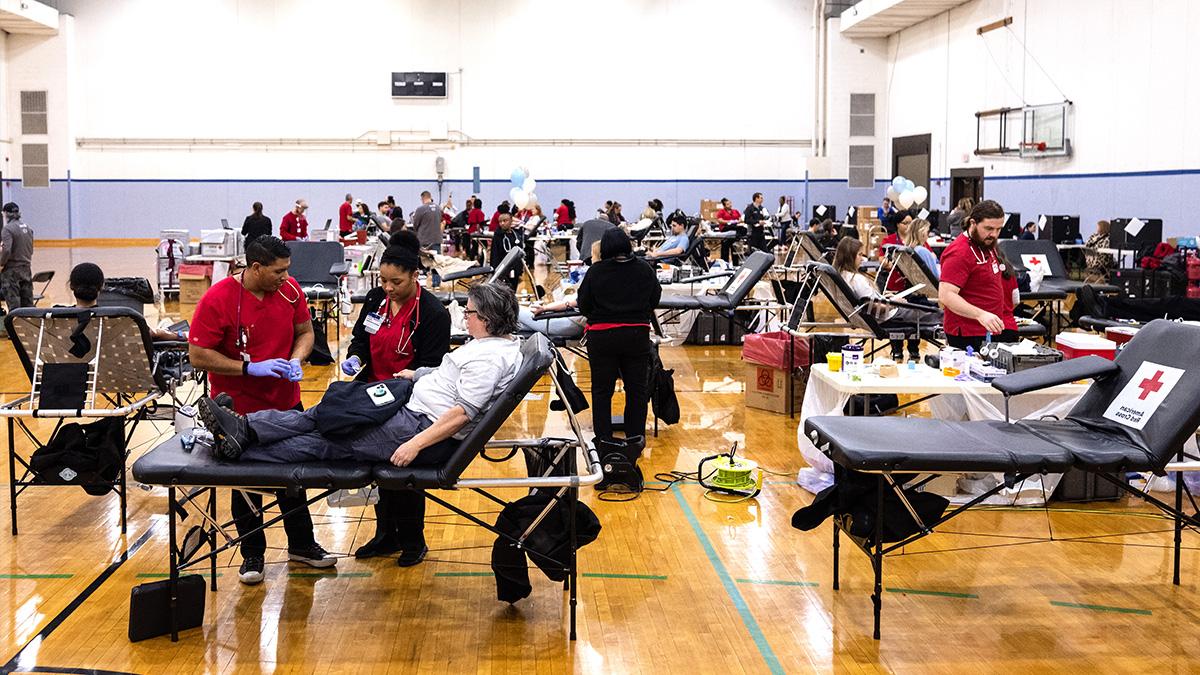 Gymnasium full of people donating blood.